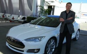 Musk posing with a Tesla