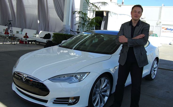 Musk posing with a Tesla